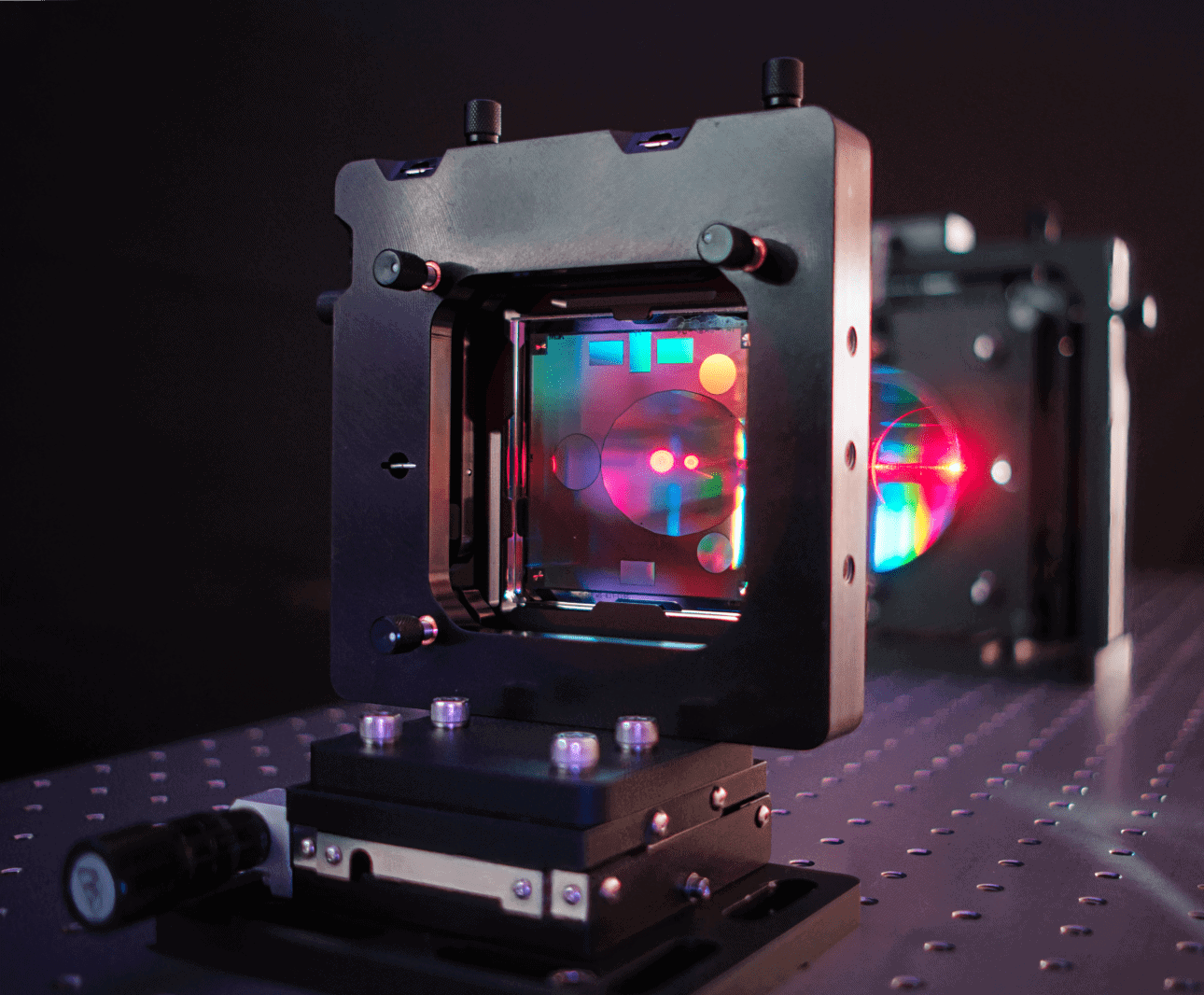 A computer-generated hologram (CGH) with alignment patterns shines rainbows of light reflected from a convex optic metrology system
