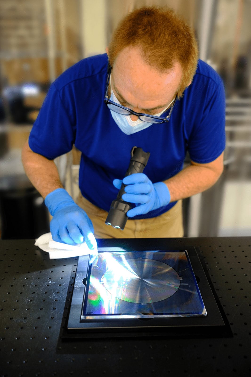 Man working on optical equipment