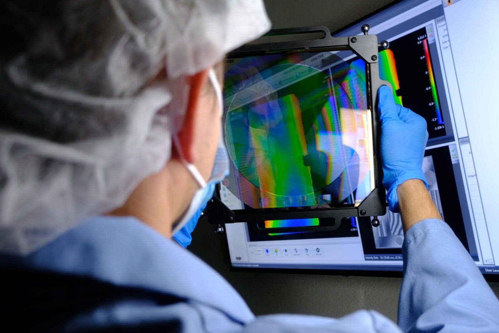 A member of the AOM team inspects a CGH for quality